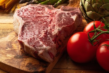 Juicy fresh piece of marbled beef steak with vegetables for grilling. Culinary background, recipe book, delicious food, Steak cooking. Close-up. macro