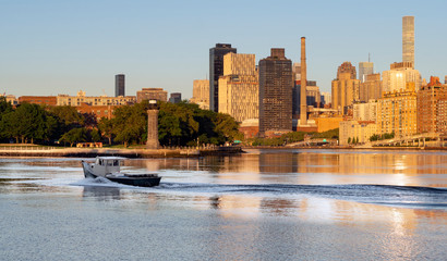 Fishing Poat Passes Roosevelt Island Lighthouse In East River New York