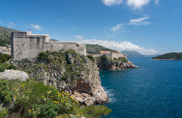 Fototapeta na wymiar Panorama of the cliffside under Fort Lawrence and city walls of the old town in Dubrovnik