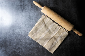 rolling pin on dark floor , for food concept