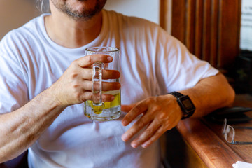 Cropped image of handsome man is drinking beer