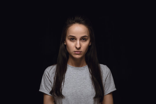 Close Up Portrait Of Young Woman Isolated On Black Studio Background. Photoshot Of Real Emotions Of Female Model. Crying, Sad, Dreary And Hopeless. Facial Expression, Human Emotions Concept.