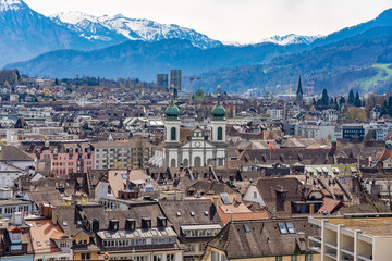 Aerial view of the red tiled roofs of the old town of Lucerne city, wooden Chapel bridge, Reuss river and Lake Lucerne from city wall, Switzerland