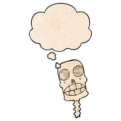 cartoon spooky skull and thought bubble in grunge texture pattern style