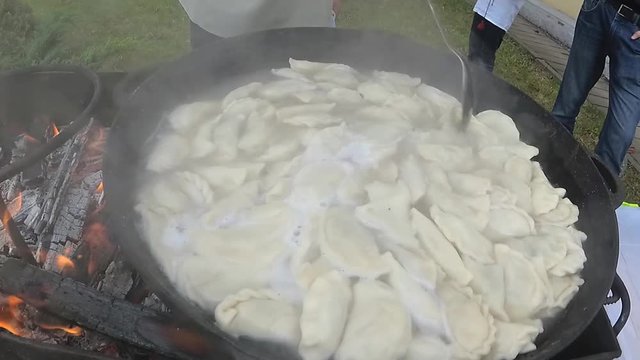 Festival street chefs. People cook food on fire outdoors.
