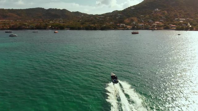 Speed boat heading into the harbour on the Caribbean island of Carriacou, Grenada