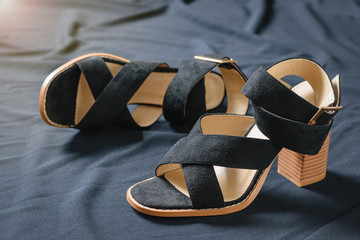 A pair of fashionable women's high-heeled shoes with black fabric.