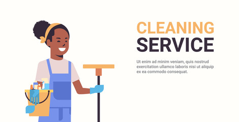 woman janitor holding bucket with tools and mop cleaning service concept smiling african american female cleaner portrait horizontal copy space flat