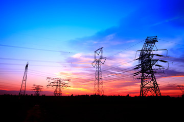 Fototapeta premium In the evening, the silhouette of high voltage towers