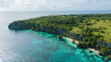 Beautiful aerial view of hill beside blue ocean with nice sky