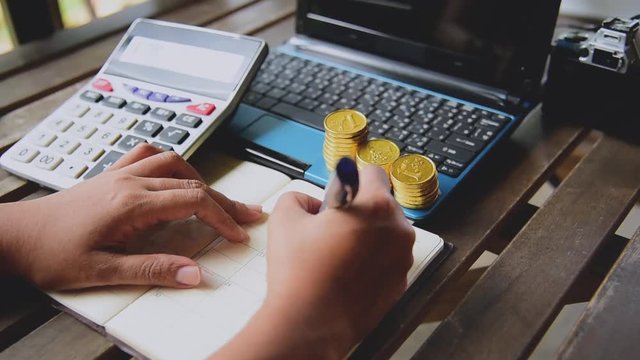 Close up accountant audit using calculater to calculate financials graph analytics data. Accountant hands Trading Information with excel file. Finance statistic report analyze working outdoor desk