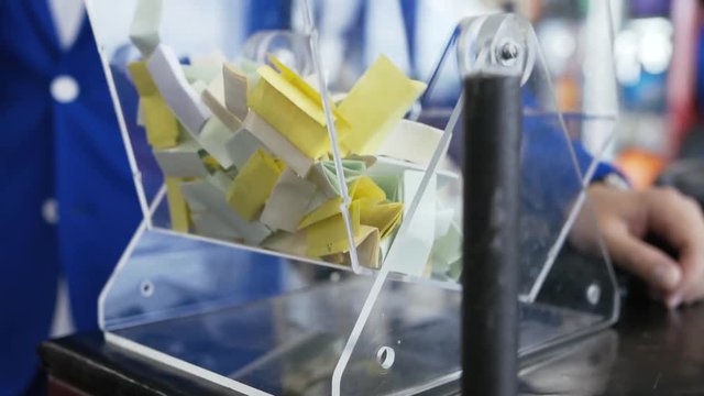 the tickets are mixed in the drum for bingo. close-up of the Lotus in the room. drawing of prizes with the help of a Lotto. bingo machine. tickets with prizes in the Lotto machine.