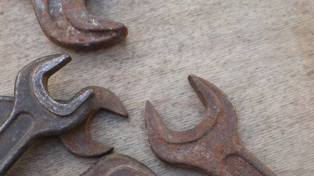 Wrench, different sizes, old and rusty. Construction and hand tools on wooden board, maintenance and reparing concept