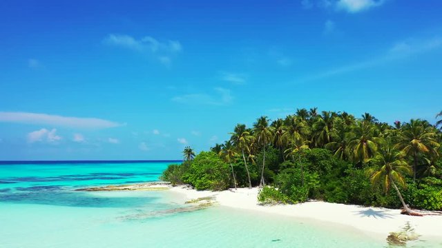 drone parallax shot of beautiful Remote Uninhabited Tropical Island In San Blas Archipelago, with palm trees and white sand beach
