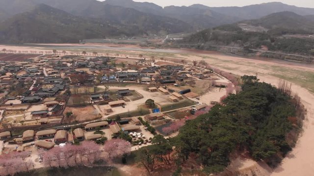 Aerial reveal traditional asian village by a river