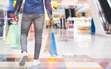 Unrecognizable african man with shopping bags in mall