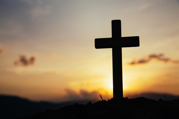 Jesus Christ cross. Easter, resurrection concept. Christian wooden cross on a background with dramatic lighting.