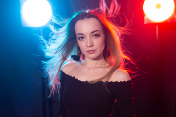Naklejka premium Portrait of young sexy woman with flashes on background