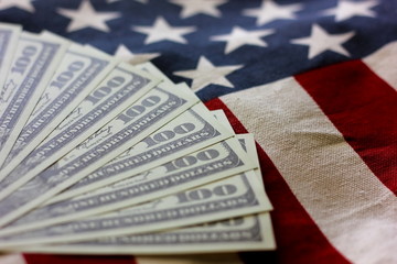 American bank note on American flag background.. 100 dollars are security of American country.