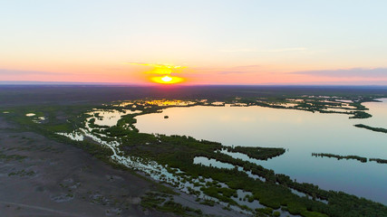 Obraz premium Aerial view over The Ailik Lake during sunset with beautiful colors and reflection from the sun. The Ailik or Aylik lake is a lake in Xinjiang Uighur Autonomous Region of China. 