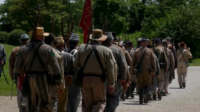 Confederate soldiers march away from the battle field.