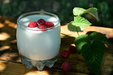 drinking yogurt with raspberries on the table