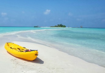 yellow cayak on white sand beach and beautiful sea background