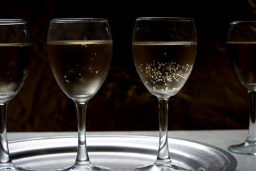 glasses with sparkling wine on a metal dressing