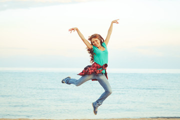 girl jumping by the sea