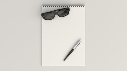Notebook with sunglasses and pen