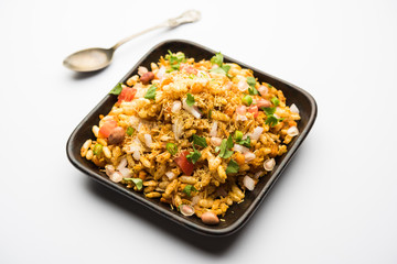 Bhelpuri Chaat/chat is a road side tasty food from India, served in a bowl or plate. selective focus