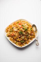 Bhelpuri Chaat/chat is a road side tasty food from India, served in a bowl or plate. selective focus