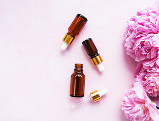 Aromatherapy essentials oils and pink peonies