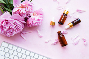 Obraz na płótnie Canvas Aromatherapy essentials oils and pink peonies