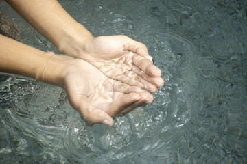 Fototapeta premium Clear natural water in woman hands.