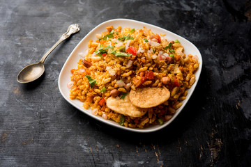 Bhelpuri Chaat/chat is a road side tasty food from India, served in a bowl or plate. selective focus