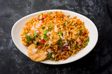 Bhelpuri Chaat/chat is a road side tasty food from India, served in a bowl or plate. selective focus
