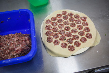 The process of making dumplings, dumplings close-up. The rolling test, the unfolding of beef, dumpling making gloved hands.