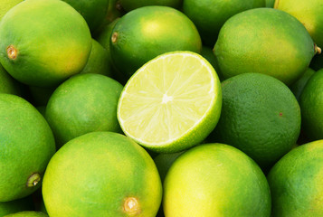 Fresh ripe limes as background, lime citrus fruit close up