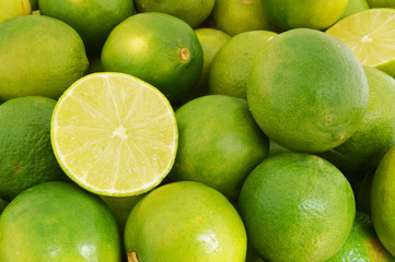 Fresh ripe limes as background, lime citrus fruit close up