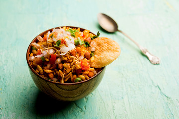 Bhelpuri Chaat/chat is a road side tasty food from India, served in a bowl or plate. selective focus