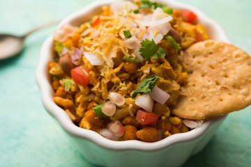 Bhelpuri Chaat/chat is a road side tasty food from India, served in a bowl or plate. selective focus