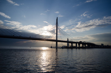 Fototapeta na wymiar The Backlight silhouette of bridge on the Neva River, Russia.