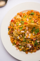 Bhelpuri Chaat/chat is a road side tasty food from India, served in a bowl or plate. selective focus