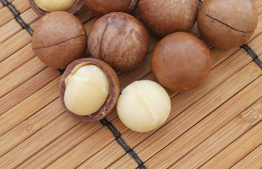 Macadamia nuts on bamboo background