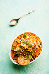Bhelpuri Chaat/chat is a road side tasty food from India, served in a bowl or plate. selective focus