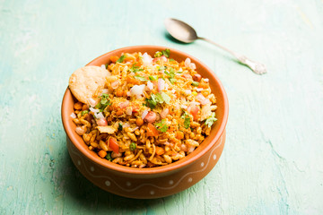 Bhelpuri Chaat/chat is a road side tasty food from India, served in a bowl or plate. selective focus
