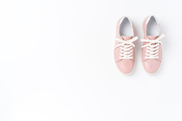 Pink women’s sneakers on background with copyspace