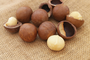 Macadamia nuts on burlap ackground