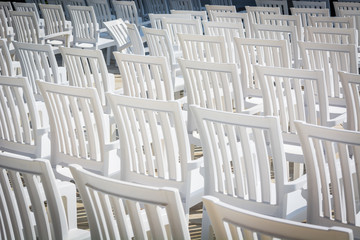 white chairs for watching performances on stage.